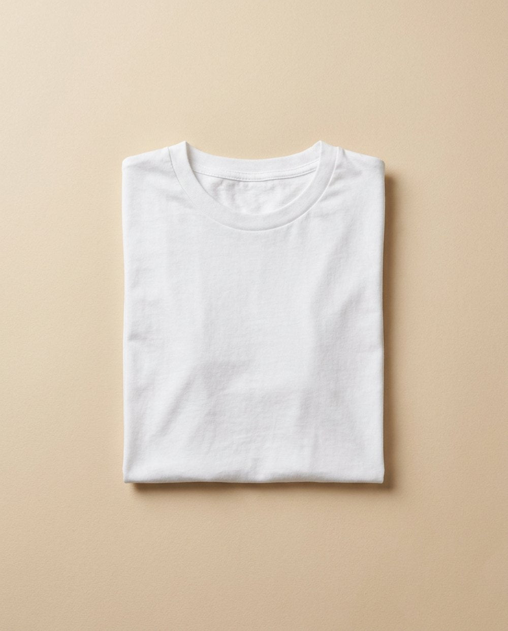 Flat-lay of a plain white t-shirt on a neutral background