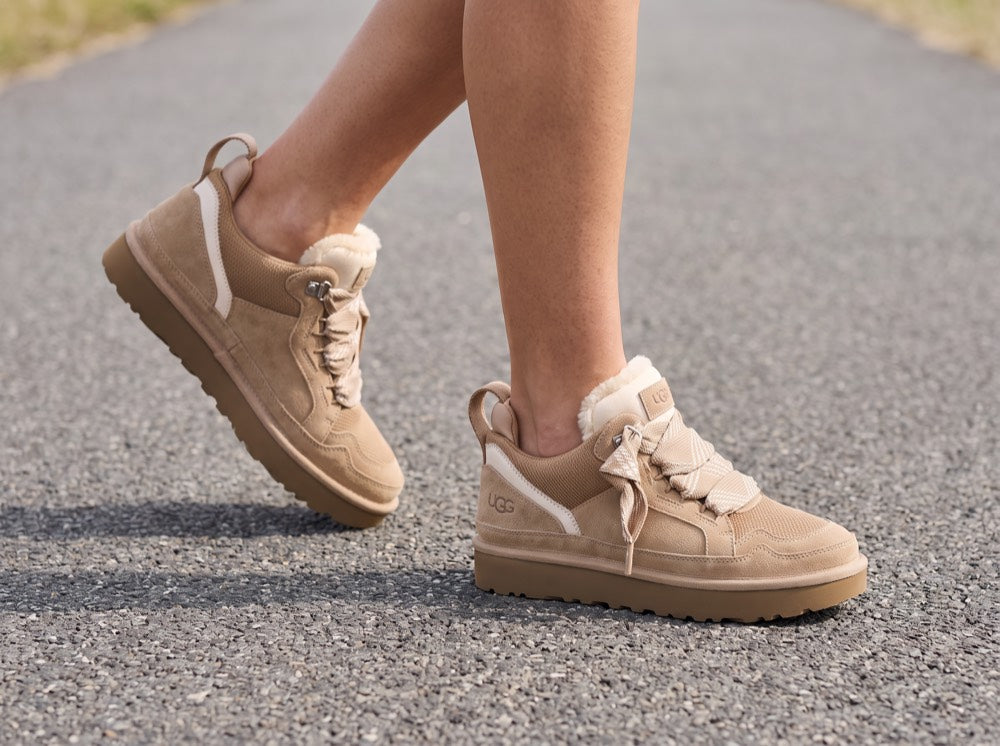 AI-generated lifestyle render — sneaker boots walking on asphalt